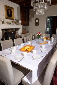 a long table with a white table cloth and a centerpiece at Domaine de charme pour groupes et evenement in Chillac +11 photos