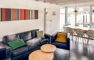 a living room with a couch and a table at Nice Home In Röbel With Sauna in Röbel