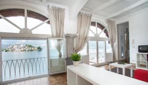uma sala de estar com vista para a água em -Ortaflats- Appartamento Gli Archi em Orta San Giulio