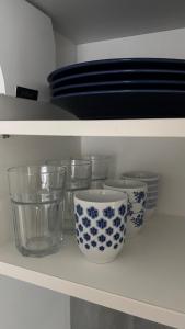 a shelf with blue and white bowls and plates at Špeluňka in Luhačovice
