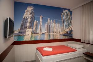 a bedroom with a painting of a city skyline at Villa Bojcic in Mostar