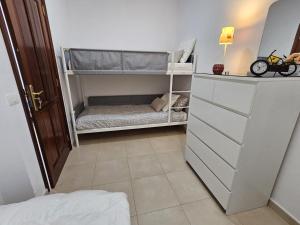 a small room with a bunk bed and a dresser at Terraza del Atlantico 1 + 2 in Barlovento