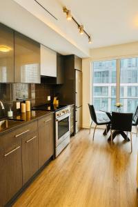a kitchen with a table and a dining room at Cozy Room & Bath Downtown Toronto in Toronto