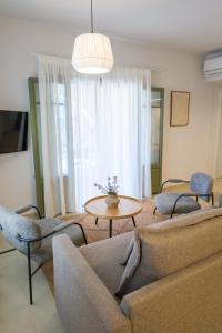 a living room with a couch and chairs and a table at Villa Selina 7 - Etheras Properties in Kythira