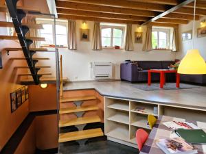 a living room with a staircase and a living room at Station Racour 'Magasin de la gare' in Landen
