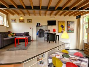 a living room with a couch and a table at Station Racour 'Magasin de la gare' in Landen