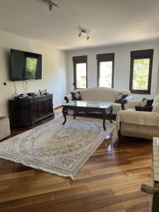 a living room with a couch and a coffee table at Prestige Old Town Villa in Sarajevo