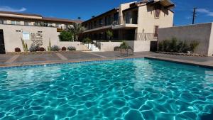 a swimming pool in front of a building at RELAX hotel and spa in Desert Hot Springs
