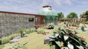 a garden with a building and some plants at Domo Geodesico de Luxo Astrum Vallis in Rio de Contas
