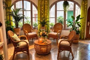 a lobby with chairs and a table with flowers on it at P&R hostals Codolar in Tossa de Mar