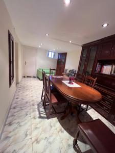 a dining room with a wooden table and chairs at A casa do teléfono in Pumares +17 photos