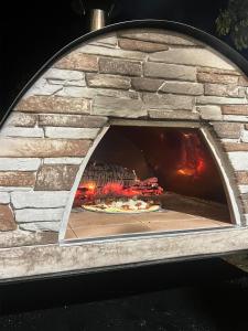 a pizza is cooking in a stone oven at Brin d'Ardèche in Saint-Prix