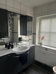 a bathroom with a white sink and a tub at Hinterhaus-Idyll Markranstädt in Markranstädt +9 photos