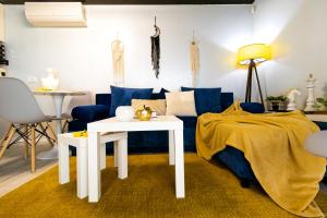 a living room with a blue couch and a table at The HIDE - Dreamland in Boldeşti-Scăeni