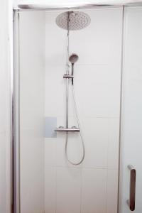 a shower with a shower head in a bathroom at Loft Valentia Olta Calpe in Calpe +11 photos