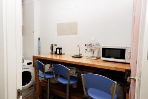 a kitchen with a table with two chairs and a microwave at Loft Valentia Olta Calpe in Calpe