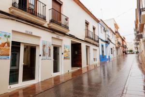 an empty city street with buildings on a rainy day at Loft Valentia Olta Calpe in Calpe