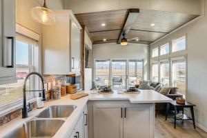 a kitchen with a sink and a living room at "Cozy Montana" Home w/ Mountain Views! in Kalispell