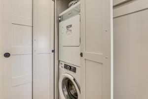 a washer and dryer in a kitchen next to a door at "Cozy Montana" Home w/ Mountain Views! in Kalispell