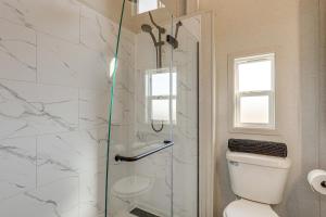 a bathroom with a toilet and a glass shower at "Cozy Montana" Home w/ Mountain Views! in Kalispell +16 photos
