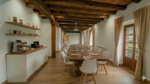 a long dining room with a long table and chairs at Casa Rural Betraunea in Sumbilla
