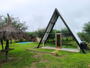 a small tent with a door in a field at Selah Cabaña de dos habitaciones in Villa Las Rosas