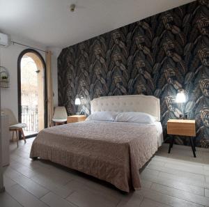 a bedroom with a bed and a wall mural at Hotel l'etoile de la ville in Montecatini Terme +9 photos