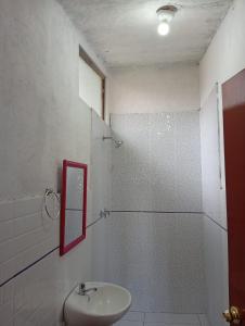 a bathroom with a sink and a shower with a mirror at Casa Shaullo-Chalets in Los Baños del Inca