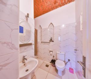 a white bathroom with a sink and a toilet at Beit El Hanna Valley View in Luxor +71 photos