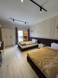 a hotel room with two beds and a window at Calmaa Kairo in Cairo