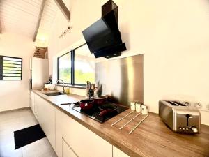 a kitchen with a counter with pots and pans on it at Villa Tiare in Bora Bora