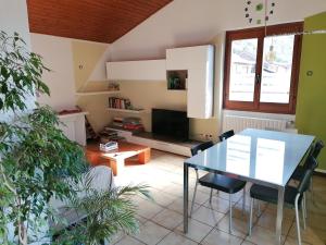 a living room with a glass table and chairs at Casa Avezza in Omegna
