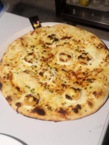 a cheese pizza sitting on top of a table at L'étang du griffolet 3 in Ussac +3 photos
