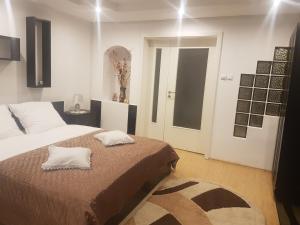 a bedroom with a bed with two pillows on it at Apartament Teilor in Râşnov
