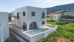 a white house with a swimming pool in a yard at Villa Selina 8 - Etheras Properties in Kythira