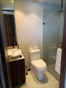 a bathroom with a toilet and a sink and a shower at Park Life Tizate in Nuevo Nayarit +21 photos