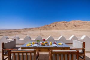 a table with food on it in the desert at Beit El Hanna Valley View in Luxor