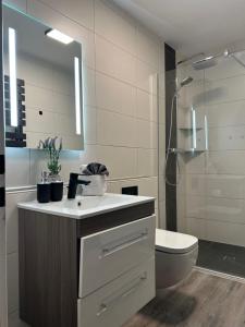 a bathroom with a sink and a toilet and a shower at Haus Pop in Borkum +40 photos