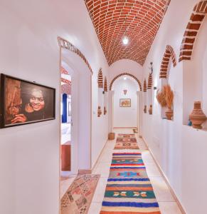 a hallway with a colorful rug on the floor at Beit El Hanna Valley View in Luxor