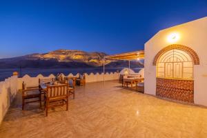 a restaurant with a view of the desert at night at Beit El Hanna Valley View in Luxor