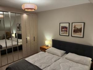 a bedroom with a large bed and a mirror at Harz-Urlaub-Altenau - Hunde willkommen in Altenau
