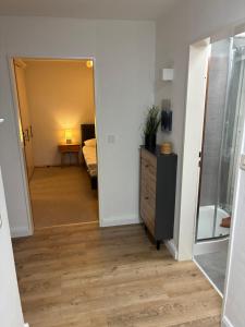 a hallway with a room with a bed and a dresser at Harz-Urlaub-Altenau - Hunde willkommen in Altenau +58 photos