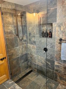 a bathroom with a shower with a glass door at Barney Views Cottage in Barney View +36 photos