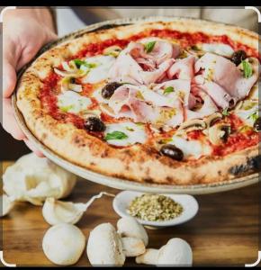 a pizza sitting on top of a table at L'étang du griffolet in Ussac