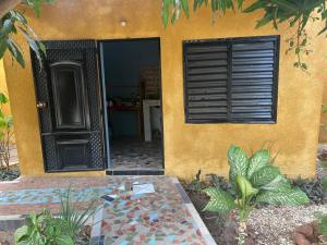 an entrance to a house with a door and window at Chez Aicha Ndangane in Ndangane