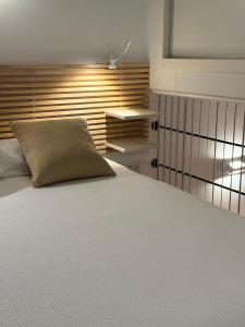 a bedroom with a white bed with a pillow on it at Mediterranean View Apartment in Denia +26 photos