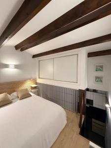a bedroom with a white bed and a window at Mediterranean View Apartment in Denia