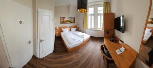 a small bedroom with a bed in a room at Hotel Friedensbruecke in Greiz