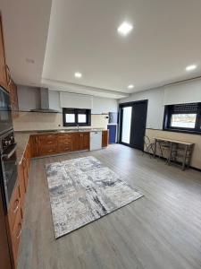 an empty kitchen with a rug on the floor at Dream House in Aldeia Nova