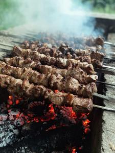 a bunch of meat cooking on a grill at Talira Luxury Camp in Wadi Rum